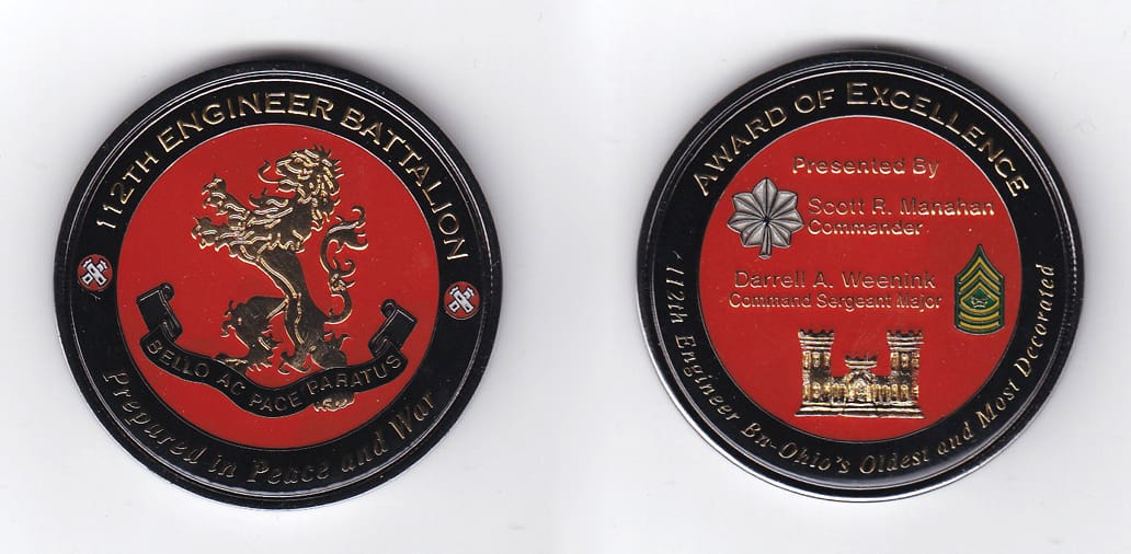 Round shaped, gunmetal black colored coin, 2 inches in diameter.