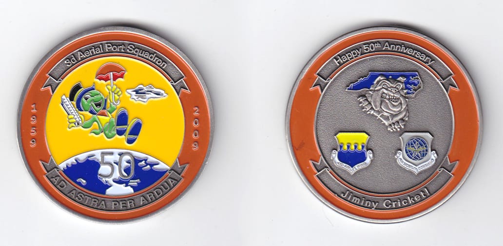 Round shaped, pewter colored coin, 2 inches in diameter.