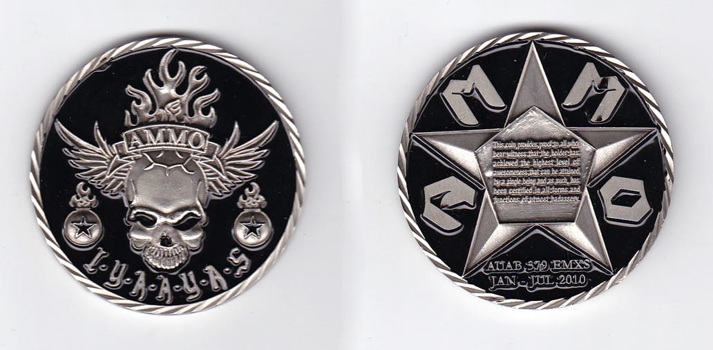 Round shaped, pewter colored coin, 2 inches in diameter.