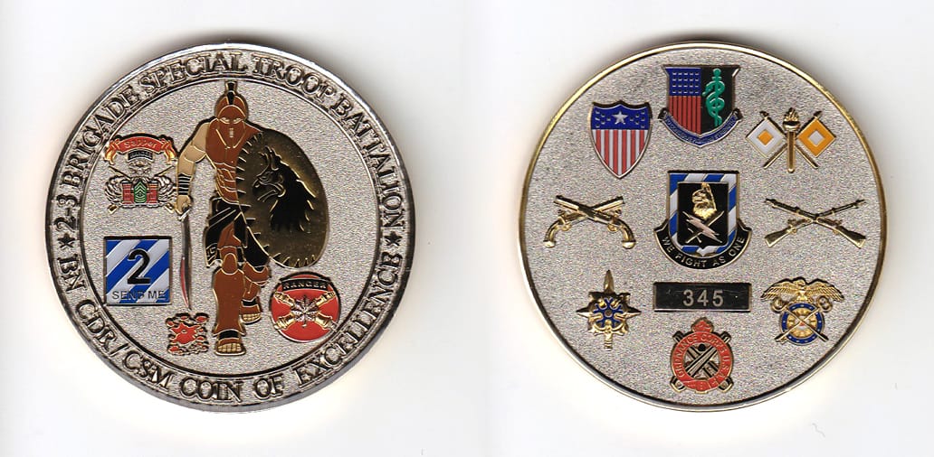 Round shaped, brass colored coin, 2 inches in diameter.