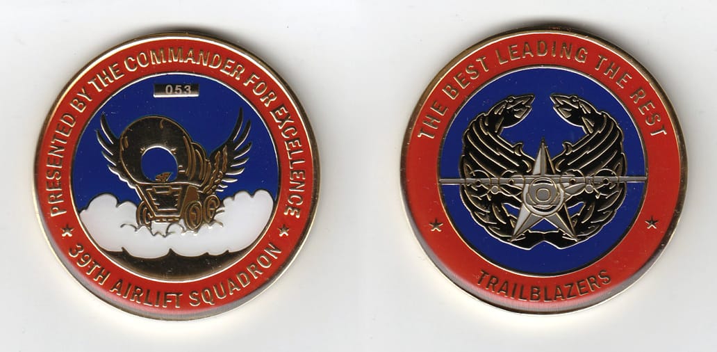 Round shaped, gold colored coin, 2 inches in diameter.