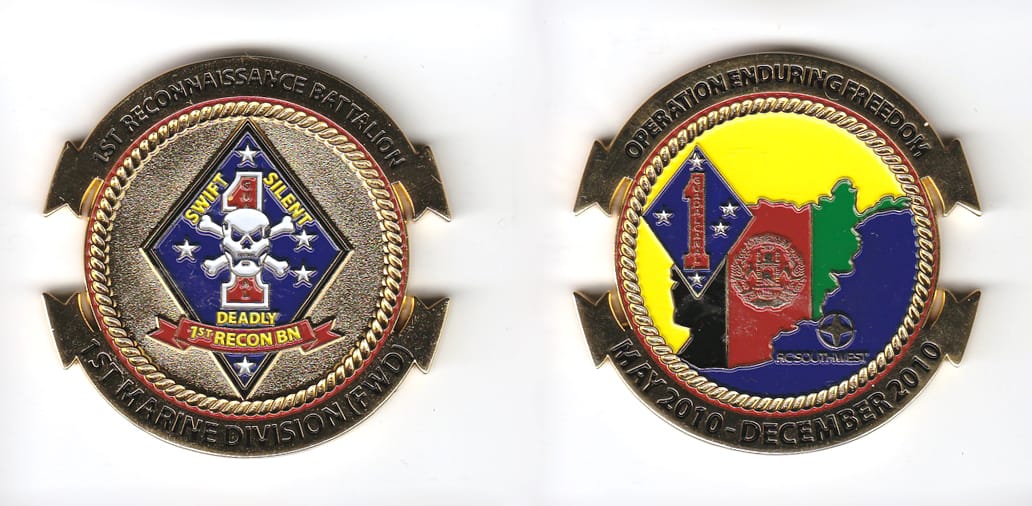 Round shaped with banners mounted above and below, gold colored coin 2 inches in diameter.