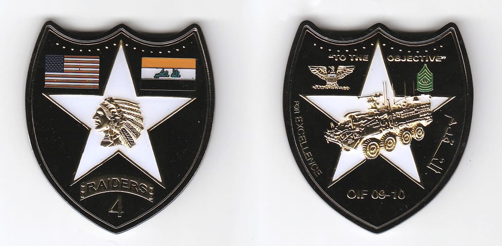 Shield shaped, brass colored coin 1-7/8 inches wide x 2-1/8 inches high.