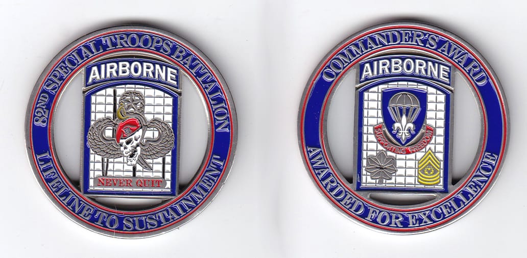 Round shaped, pewter colored coin, 2 inches in diameter.