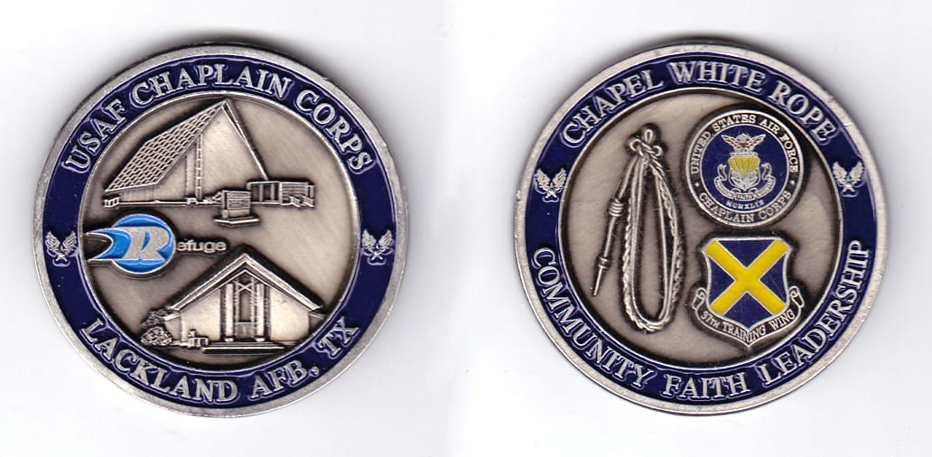 Round shaped, pewter colored coin, 2 inches in diameter.