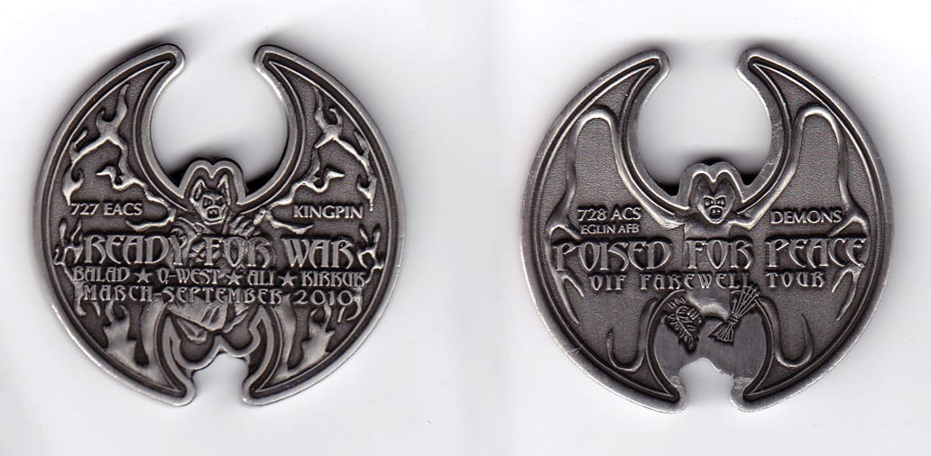 Round shaped with cut out areas on top and bottom, pewter colored coin, 2 inches in diameter.