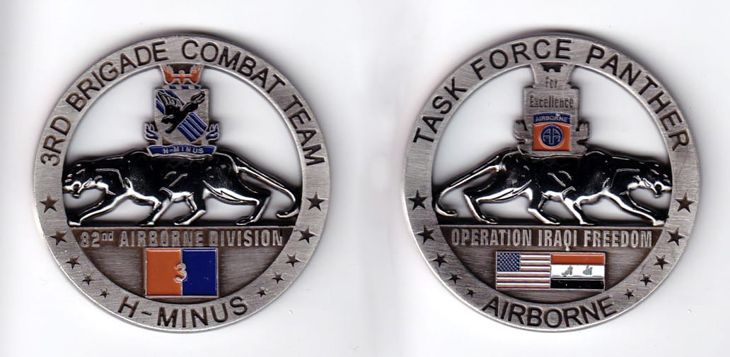 Round shaped, pewter colored coin, 2 inches in diameter.