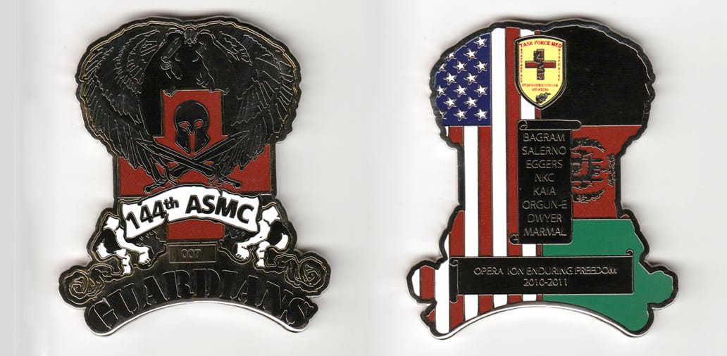 Shield shaped, with banner mounted beneath and eagle mounted above, silver colored coin 2-3/4 inches wide x 2-1/2 inches...