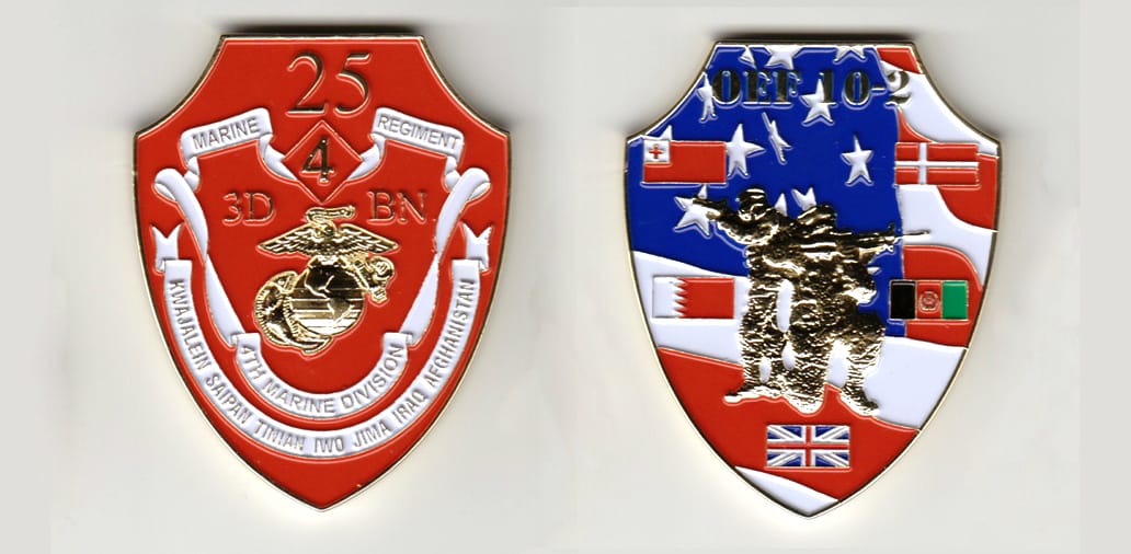 Shield shaped, gold colored coin 1-7/8 inches wide x 2-1/2 inches high.