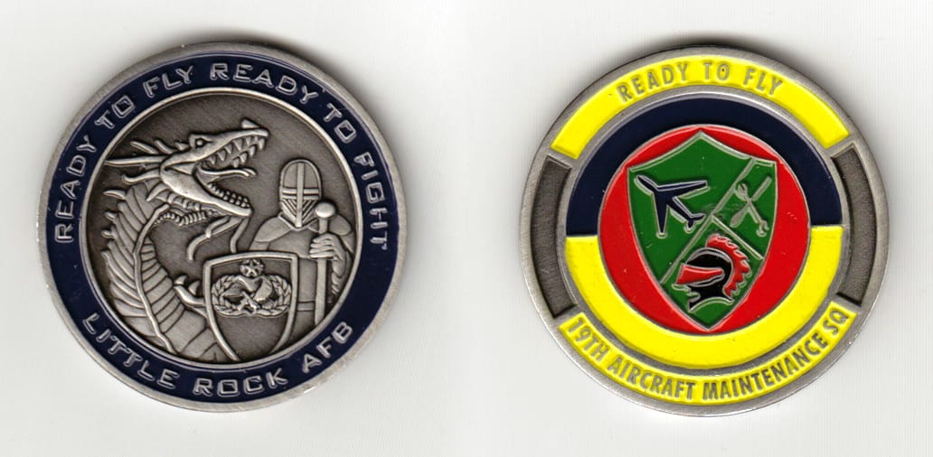 Round shaped, pewter colored coin 1-3/4 inches in diameter.