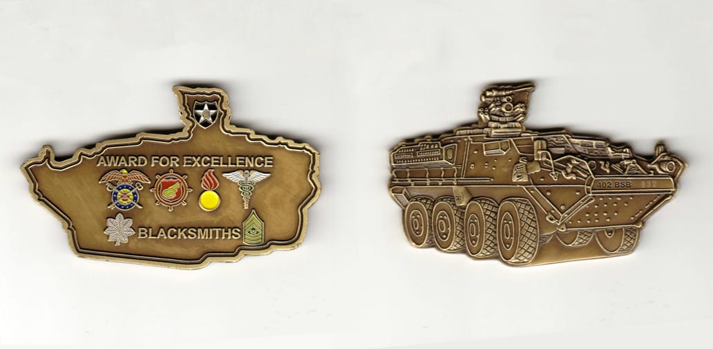 Armored vehicle shaped, brass colored coin 3 inches wide x           1-13/16 inches high.