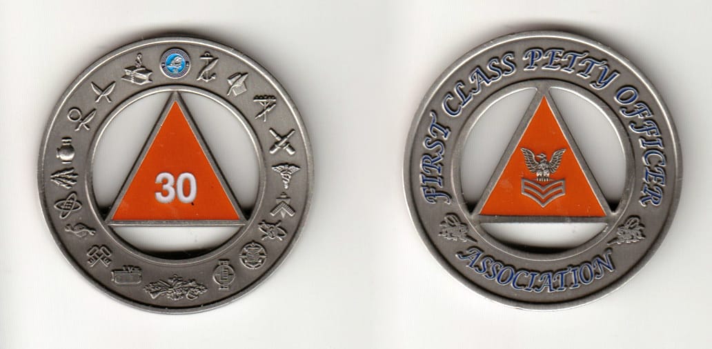 Round shaped, pewter colored coin 2 inches in diameter.