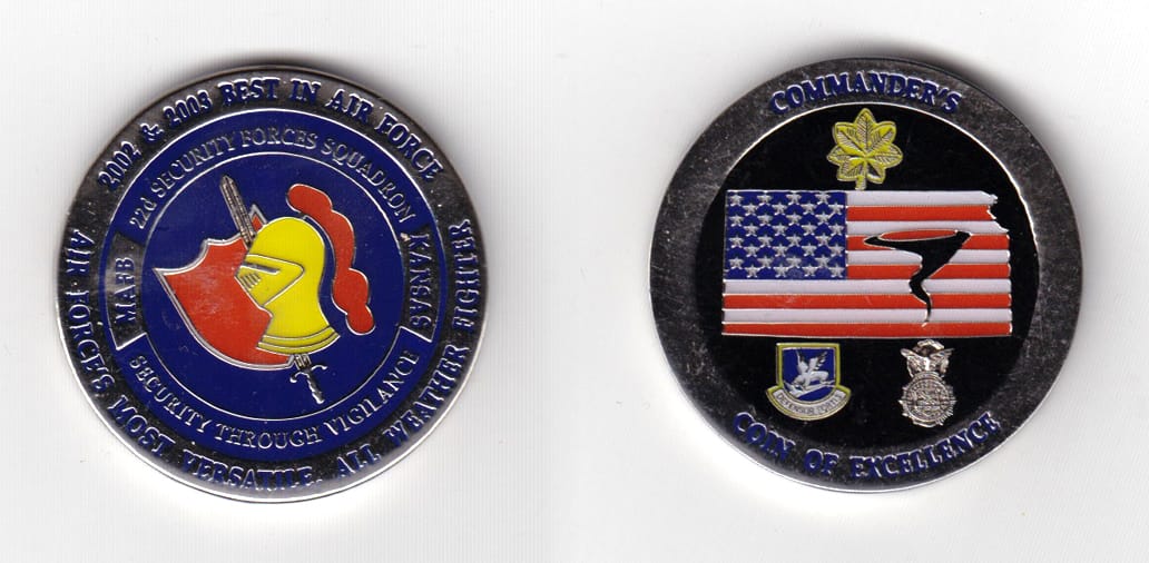 Round shaped, silver colored coin 1-1/2 inches in diameter.