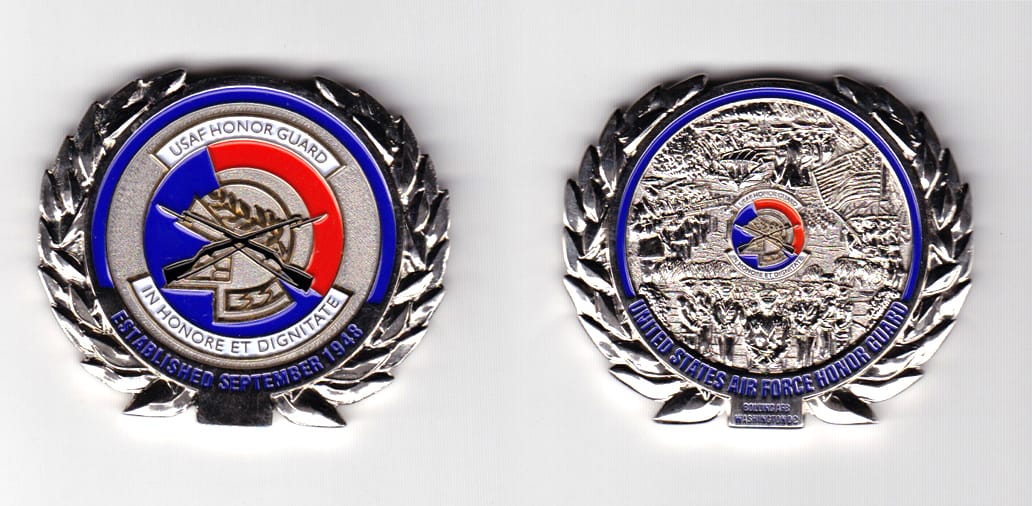 Oval shaped, silver  colored coin 2 inches wide x 1-5/8 inches high.