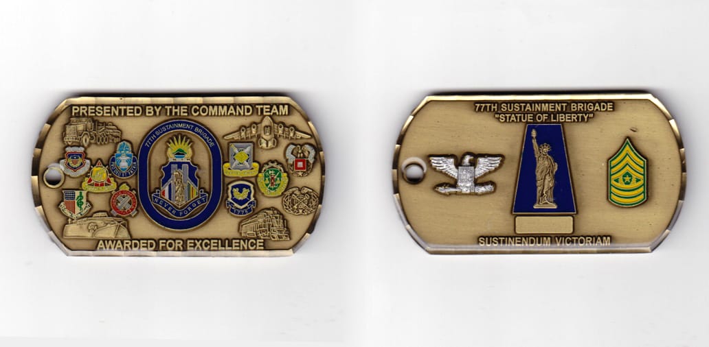 Dog tag shaped, antique brass  colored coin 2-7/8 inches wide x 1-5/8 inches high.