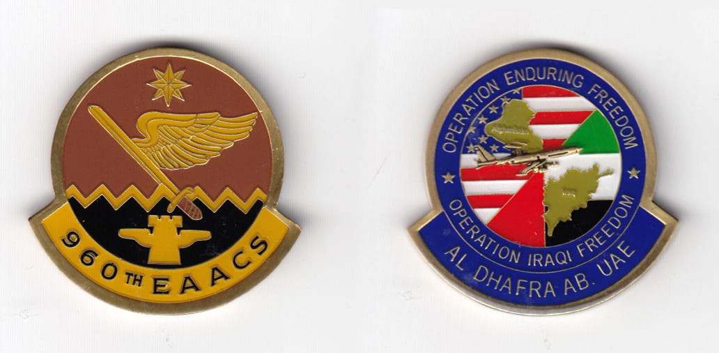 Round shaped, with banner mouned beneath, brass  colored coin 1-1/8 inches wide x 1-5/8 inches high.