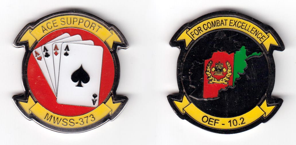 Round shaped, with banner mouned above and beneath, silver  colored coin 1-5/8 inches wide x 1-3/4 inches high.