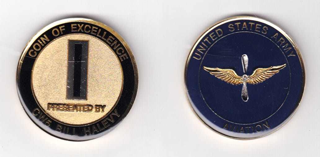 Round shaped, gold colored coin 1-3/4 inches in diameter.