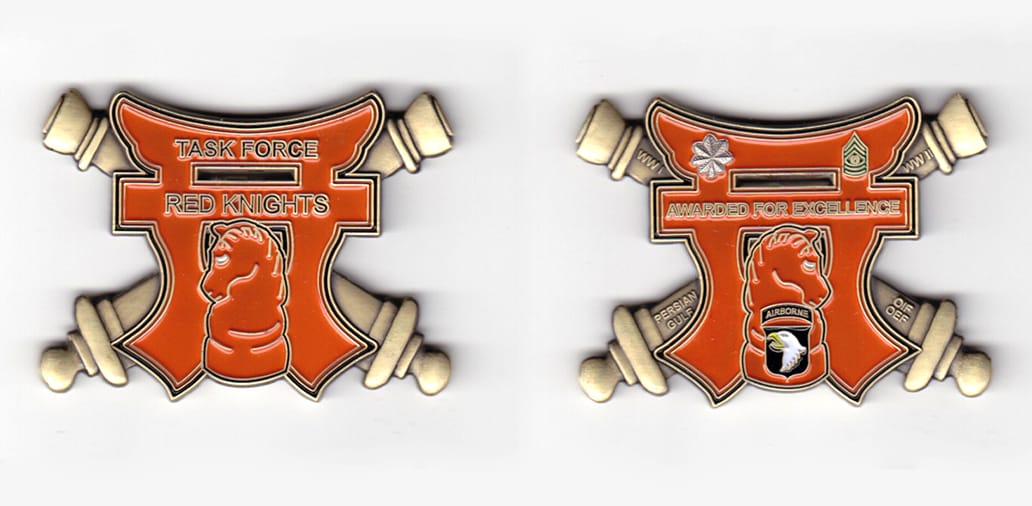 Torri shaped, with crossed cannons extending, brass  colored coin 2-1/2 inches wide x 2 inches high.