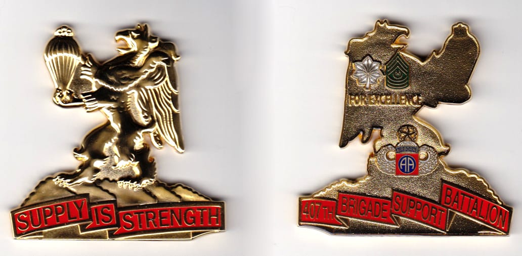 Lion Rampant holding parachute standing on mountain range,  gold colored coin, 2-1/2 inches wide x 2-1/2 inches high.