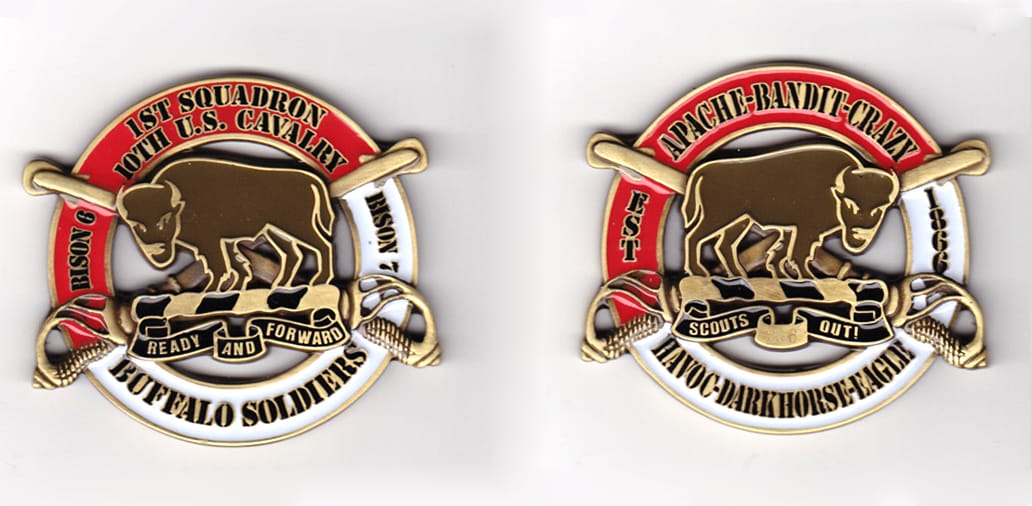 Round shaped with crossed sabers extending, brass colored coin, 2-3/4 inches wide x 2-1/2 inches high.