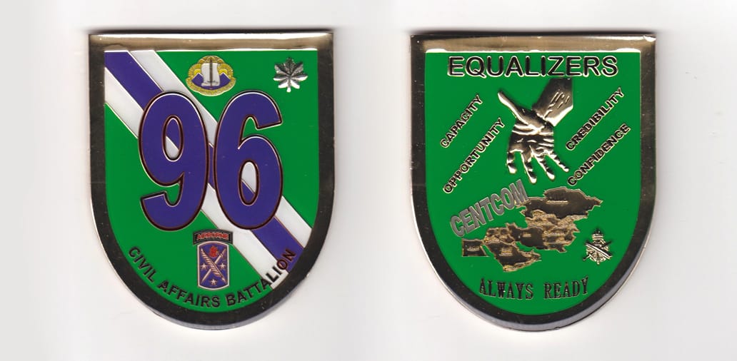 Shield shaped, gold colored coin, 2-1/2 inches wide x 3 inches high.