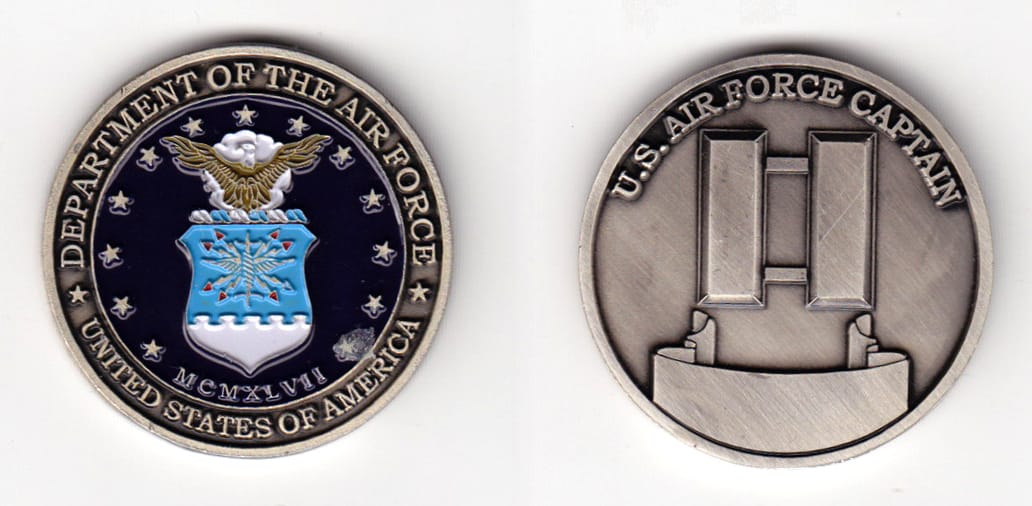 Round shaped, pewter colored coin, 1-1/2 inches in diameter.