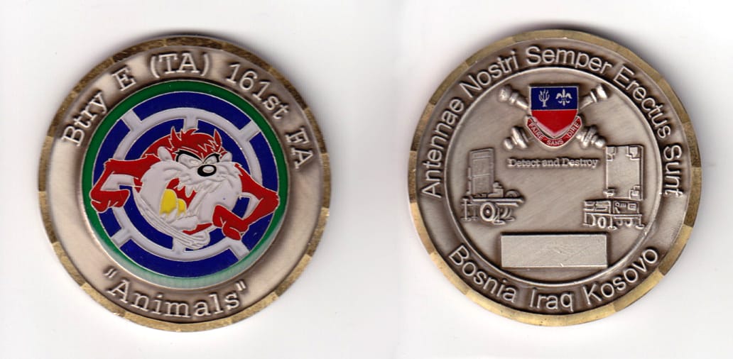 Round shaped, pewter colored coin, 2 inches in diameter.