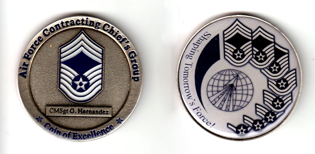 Round shaped, pewter colored coin, 2 inches in diameter.