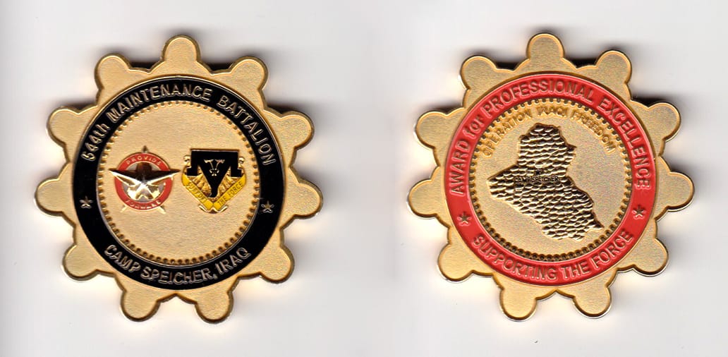 Round, sprocket shaped, gold colored coin, 2 inches in diameter.