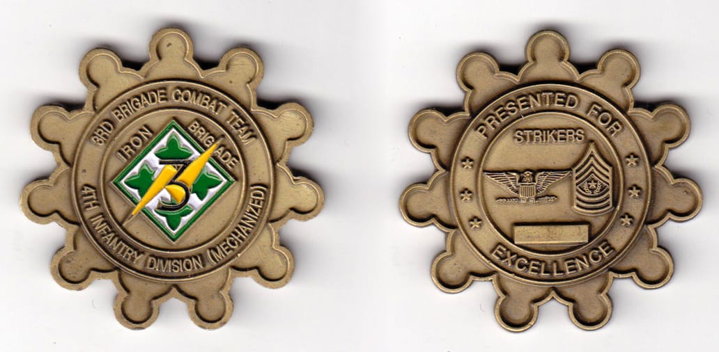 Round, sprocket shaped, brass colored coin, 2 inches in diameter.