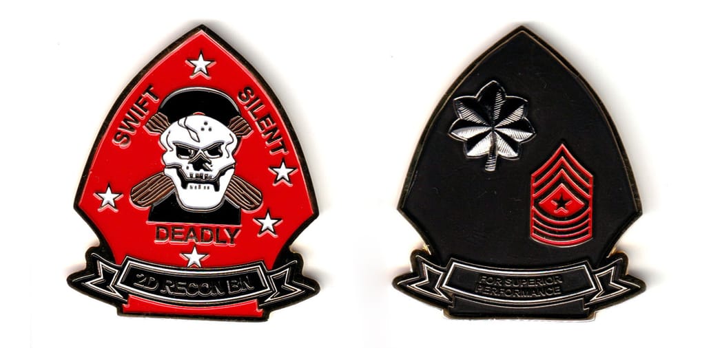 Arrowhead shaped with banner mounted beneath, gold colored coin, 2 inches wide x 2-1/4 inches high.