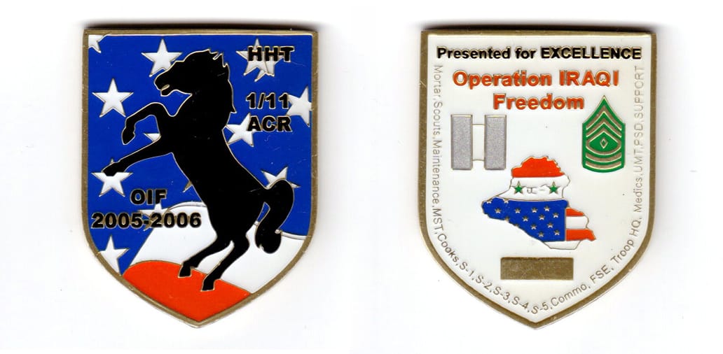 Shield shaped, brass colored coin, 1-5/8 inches wide x 2 inches high.