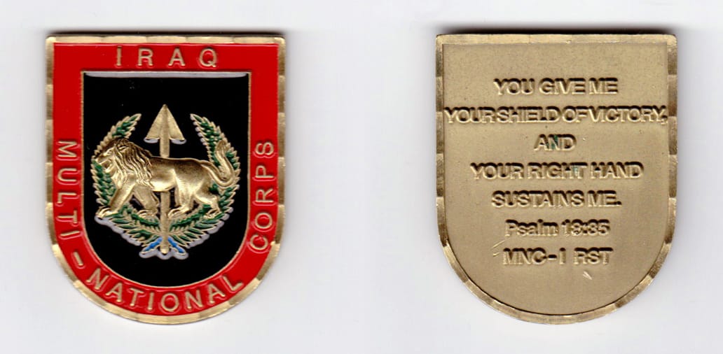 Shield shaped, brass colored coin, 1-5/8 inches wide x 2 inches high.