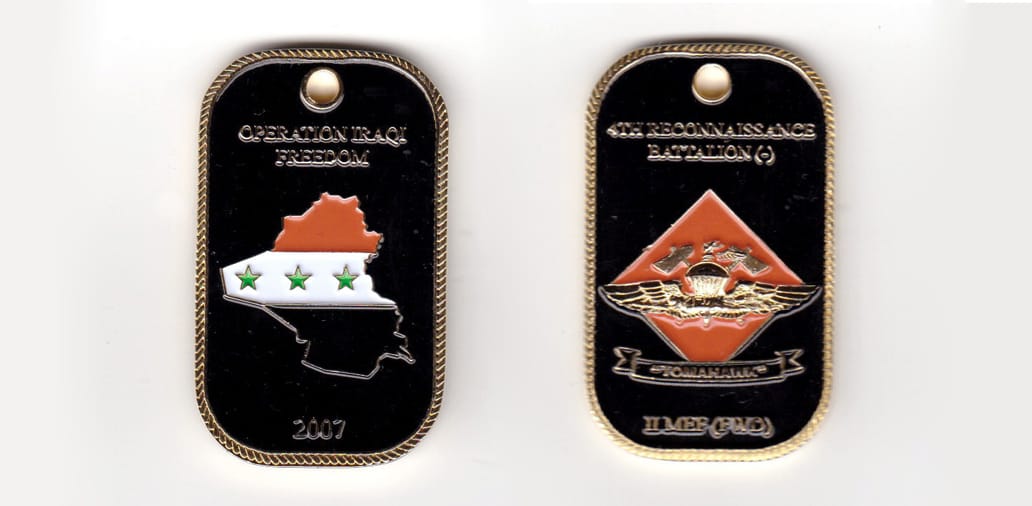 Dog tag shaped, gold colored coin, 1-1/4 inches wide x 2 inches high.