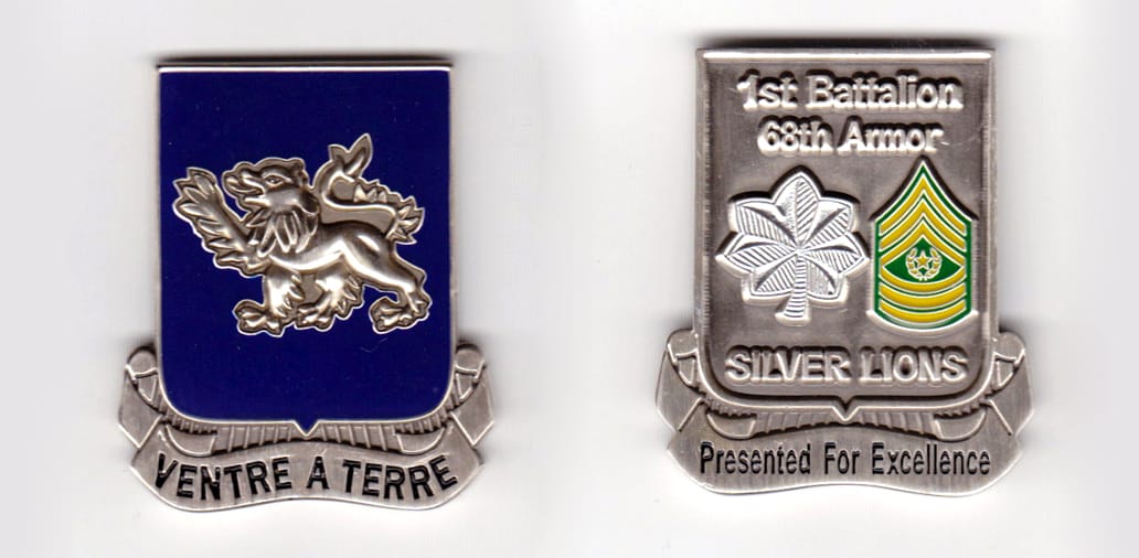 Shield shaped, with banner mounted beneath, pewter colored coin, 2 inches wide x 1-7/8 inches high.