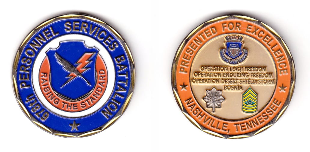 Round shaped, silver colored coin, 2 inches in diameter.