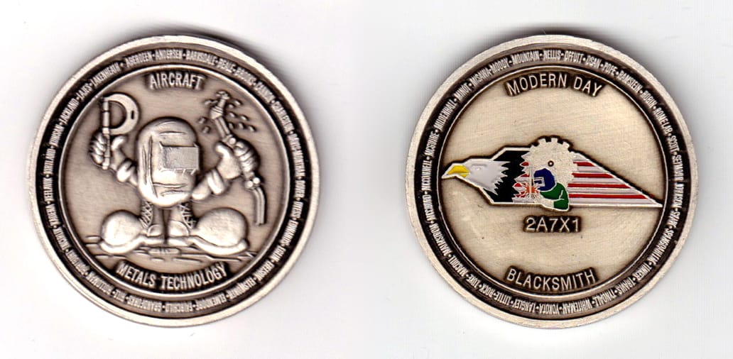 Round shaped, pewter colored coin, 2 inches in diameter.