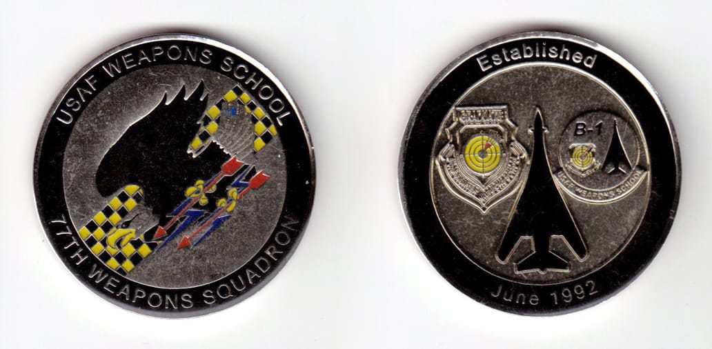 Round shaped, silver colored coin, 2 inches in diameter.