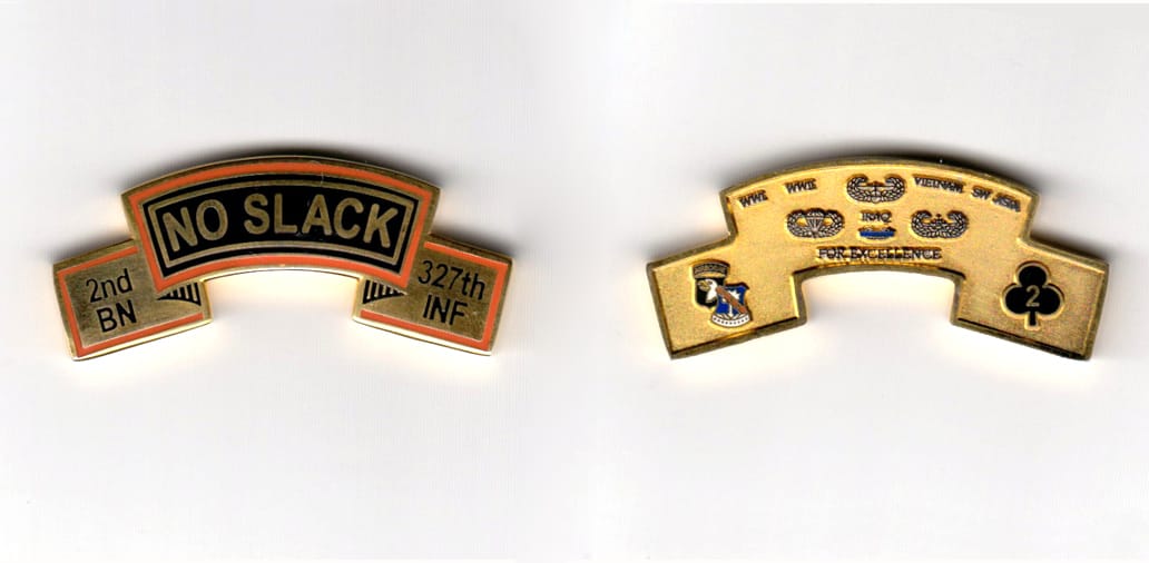 Banner shaped, gold colored coin, 2 inches wide x 7/8 inches high.