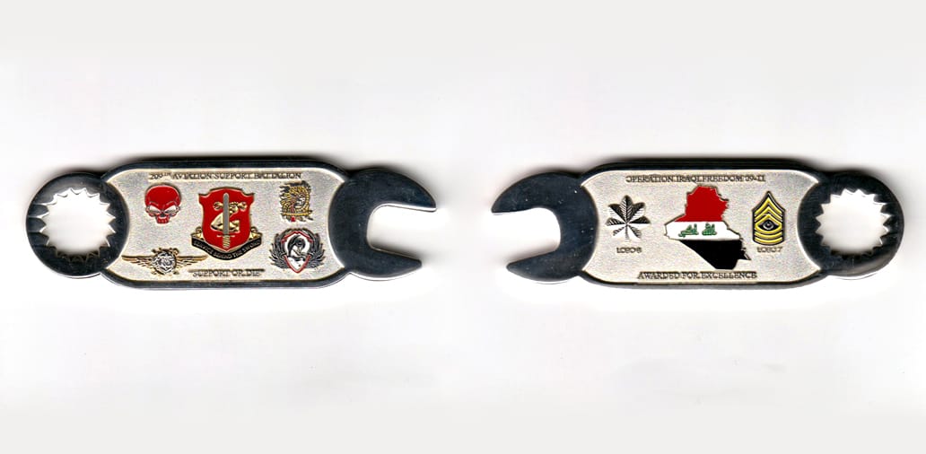 Wrench shaped, silver colored coin,3-1/4 inches wide x 1 inch high.