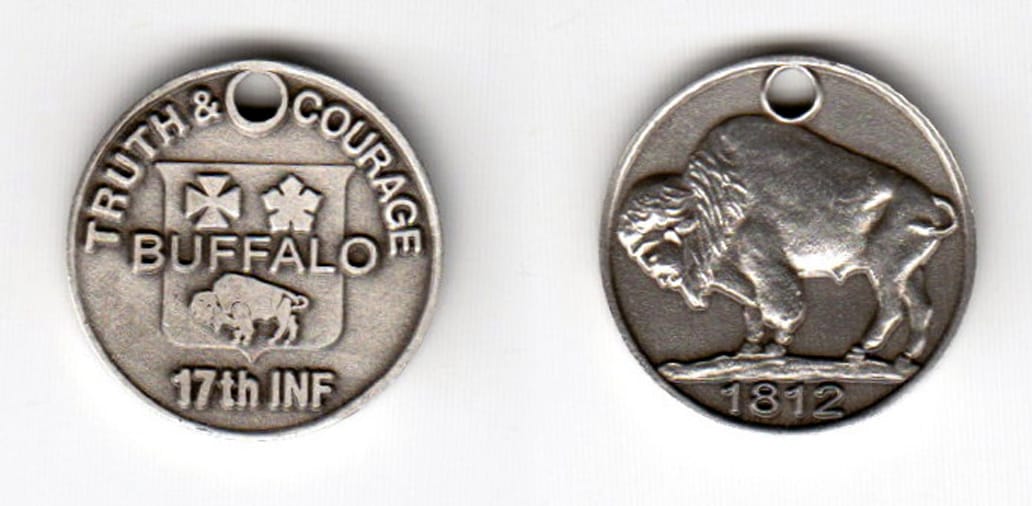 Round shaped, pewter colored coin, 7/8 inches in diameter.