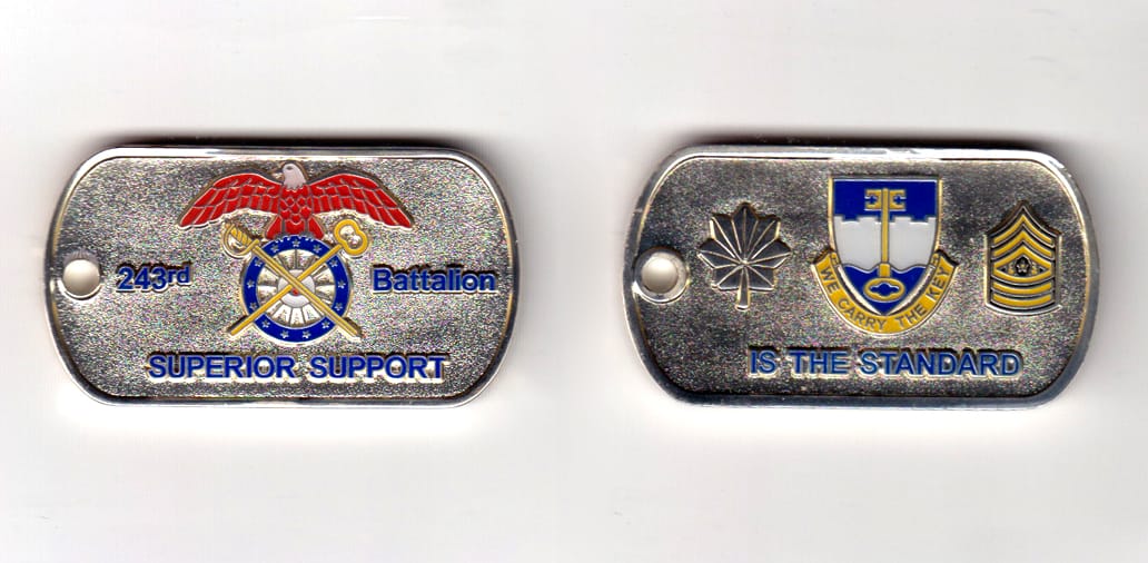 Dog tag shaped, silver colored coin, 2 inches wide x 1-1/2 inches high.