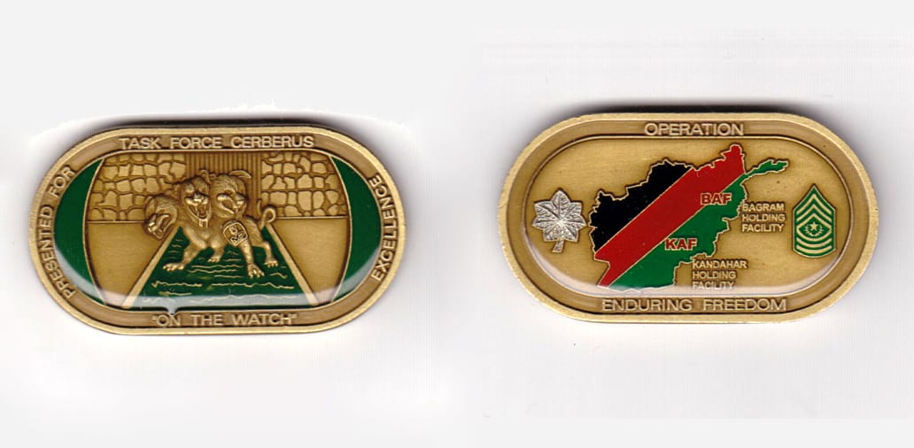 Retangular  with rounded corners shaped, brass colored coin,        2-1/8 inches wide x 1-1/8 inches high.