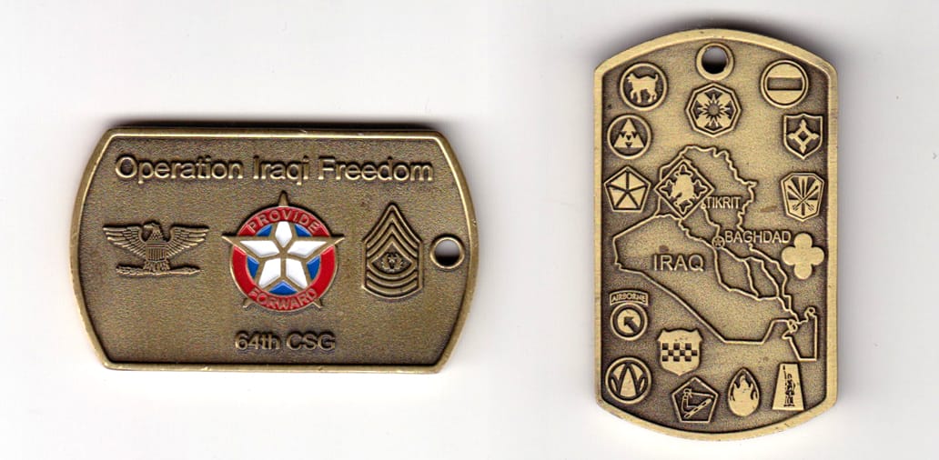 Dog tag shaped, brass colored coin, 2 inches wide x 1-1/8 inches high.