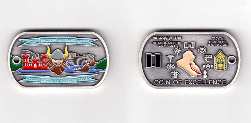 Dog tag shaped, pewter colored coin, 2 inches wide x 1-1/8 inches high.