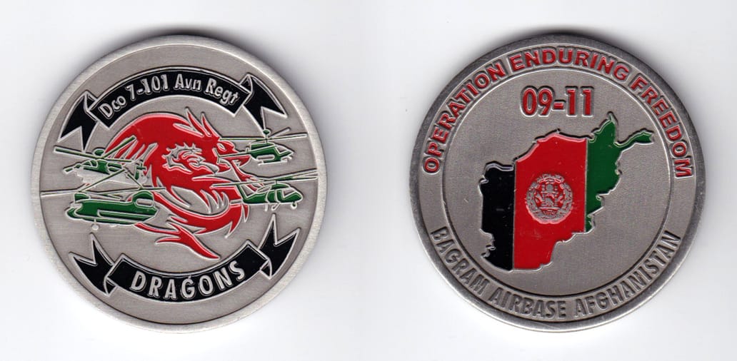 Round shaped, pewter colored coin, 2 inches in diameter.