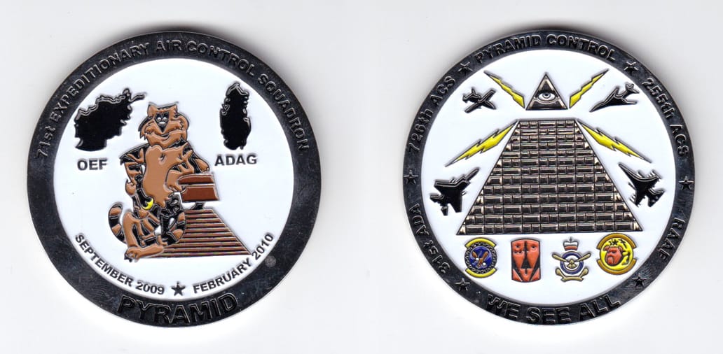 Round shaped, silver colored coin, 2 inches in diameter.