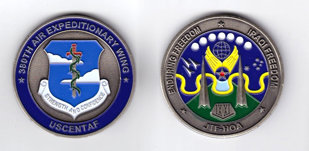 Round shaped, pewter colored coin, 2 inches in diameter.