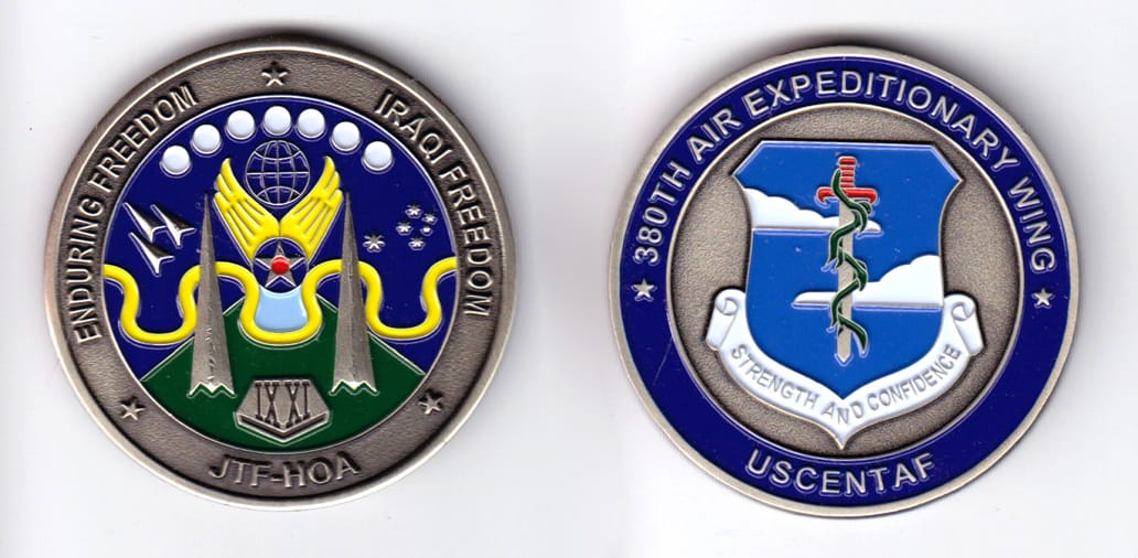 Round shaped, pewter colored coin, 2 inches in diameter.